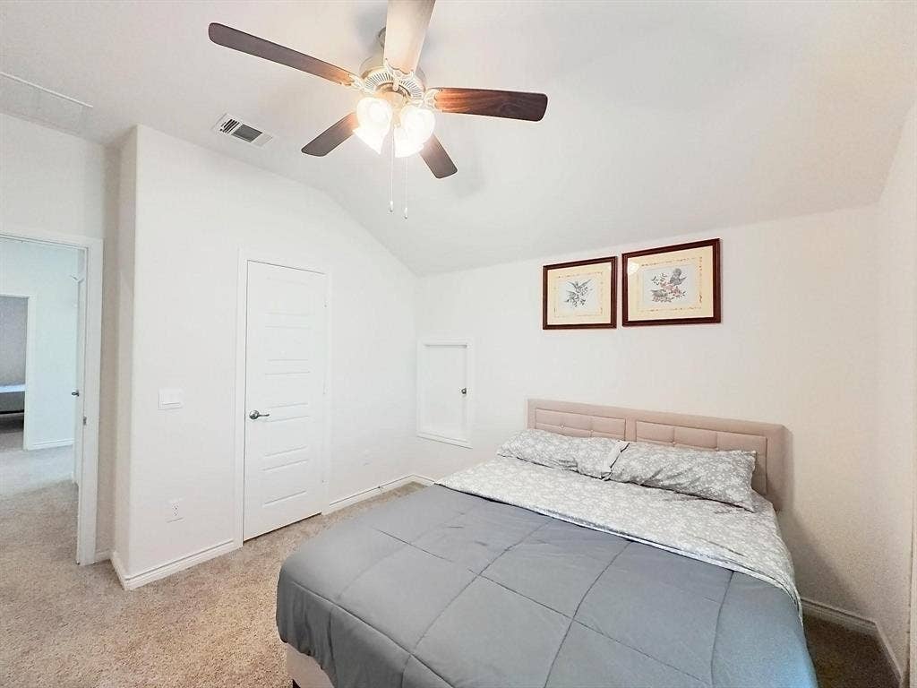 7400 Seton Place, McKinney, TX 75071 Vaulted ceiling with an integrated three-light ceiling fan, carpeted flooring, and a recessed storage compartment