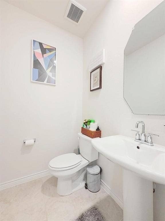 7400 Seton Place, McKinney, TX 75071 Powder room featuring a pedestal sink, dual-handle chrome faucet, wall-mounted octagonal mirror, and tile flooring