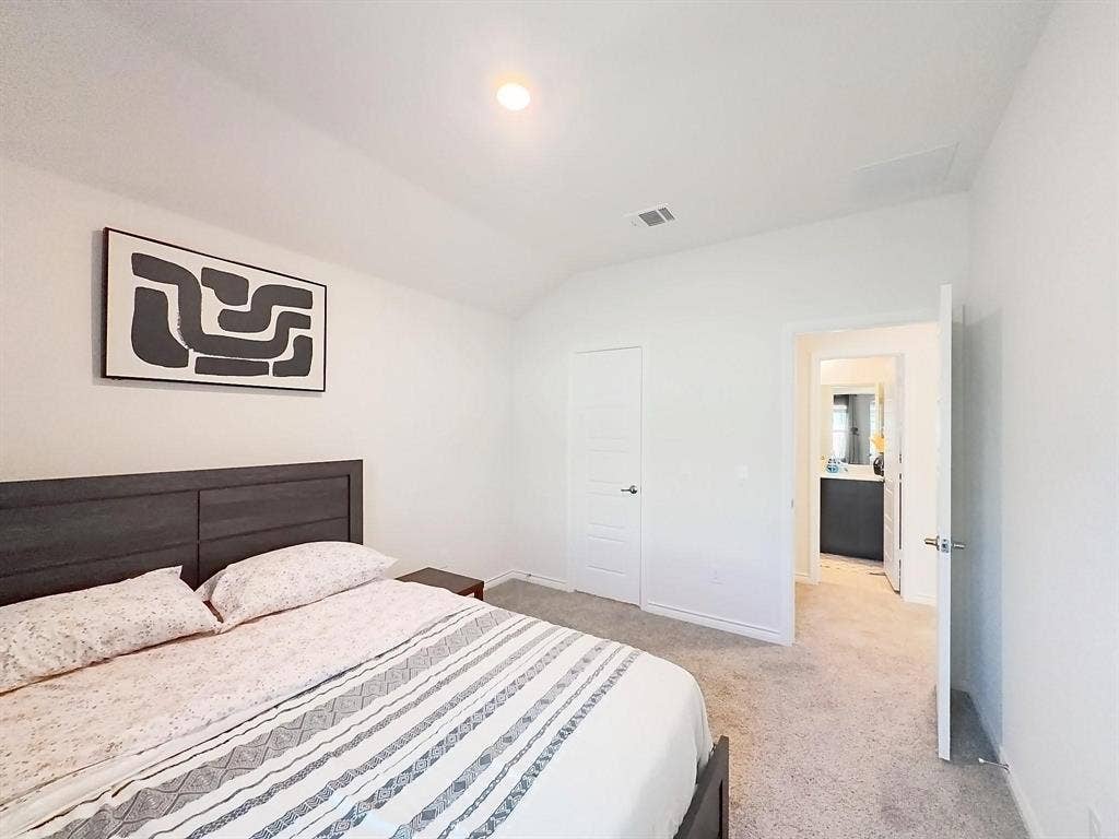 7400 Seton Place, McKinney, TX 75071 Room featuring vaulted ceilings, neutral carpeting, and a recessed lighting fixture