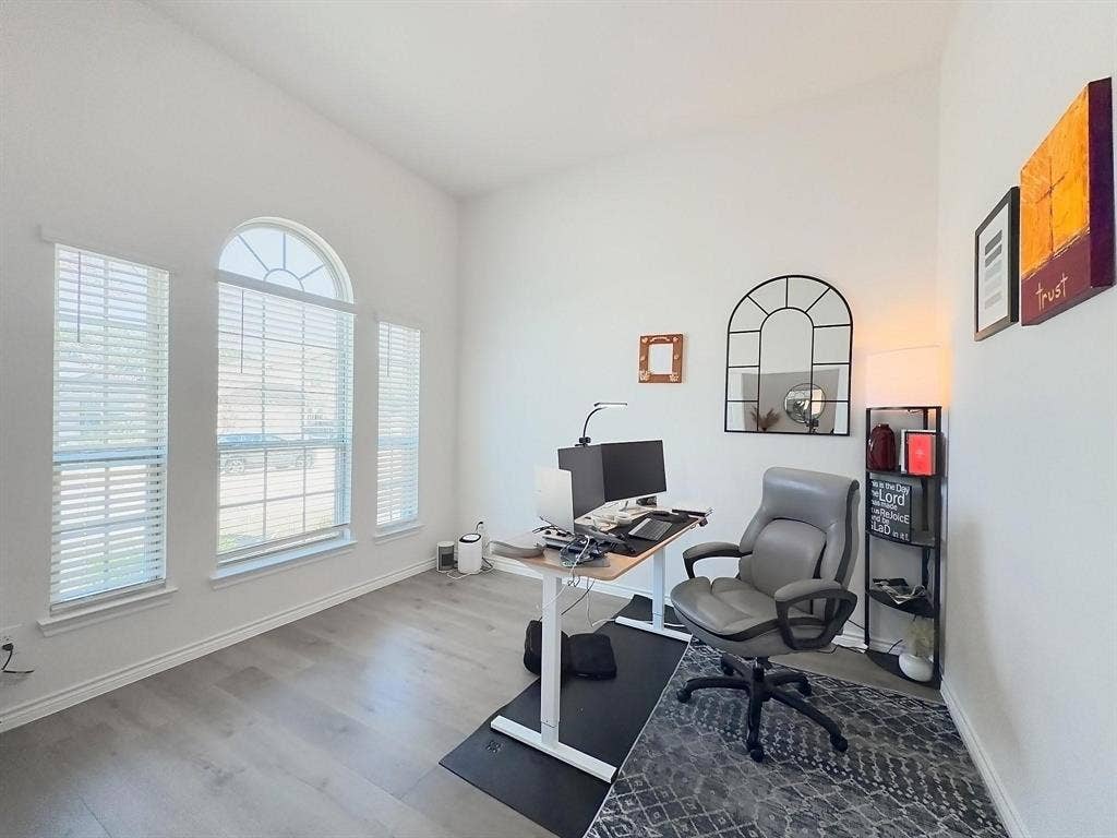 7400 Seton Place, McKinney, TX 75071 High ceilings featuring a trio of windows with an arched transom, wood-finish flooring, and neutral wall tones