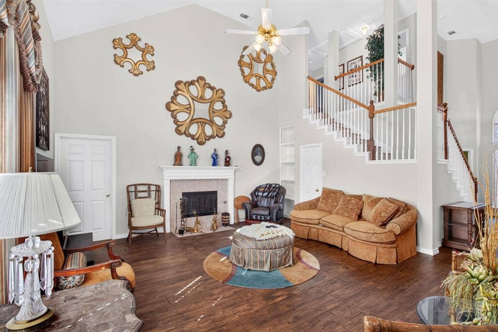 10657 Coach House Lane, Frisco, TX 75035 Gas fireplace anchors the living area, with a view toward the open staircase.