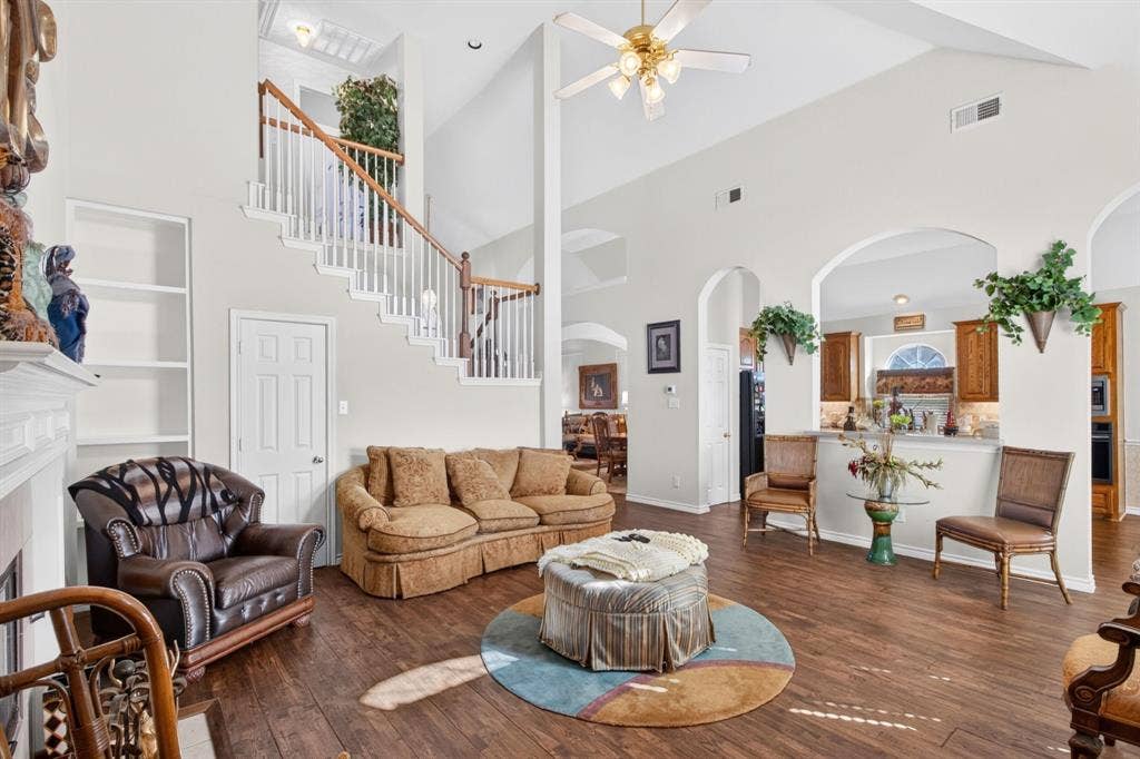 10657 Coach House Lane, Frisco, TX 75035 Soaring ceilings, an open staircase and wood-look flooring connect the main living spaces.