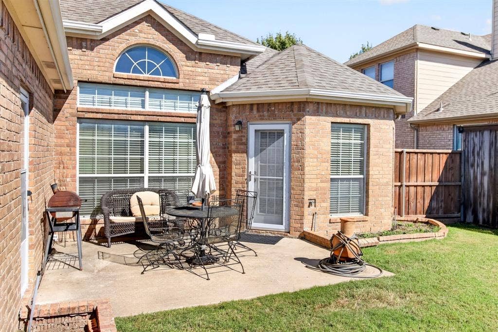 10657 Coach House Lane, Frisco, TX 75035 Patio off the main living spaces offers a place for outdoor seating.
