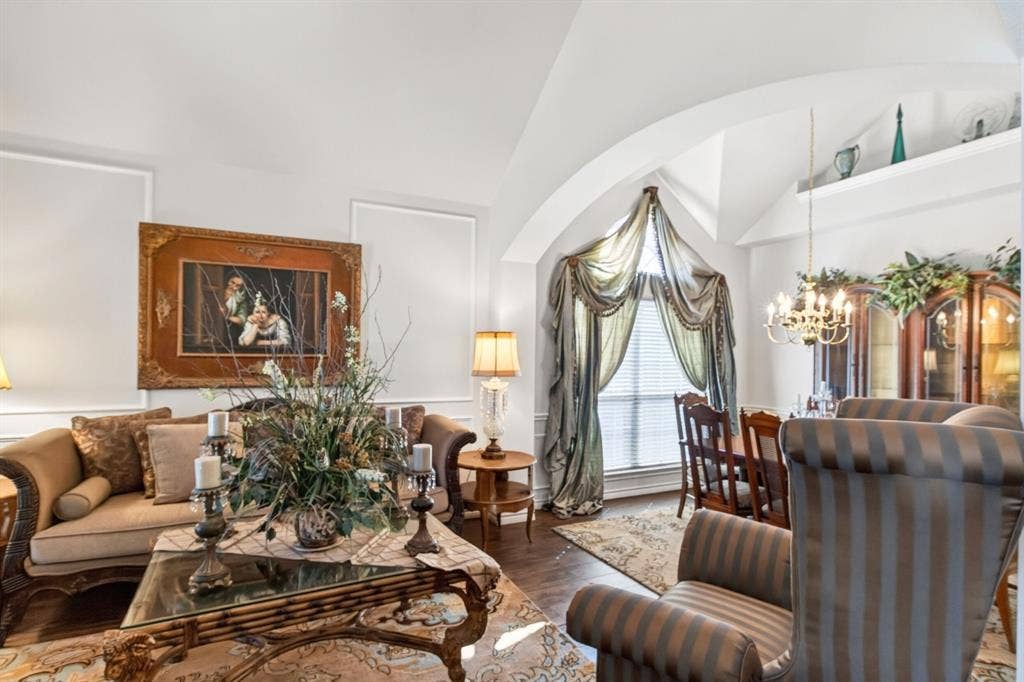10657 Coach House Lane, Frisco, TX 75035 Formal living room with tall ceilings and an open connection to the dining area.