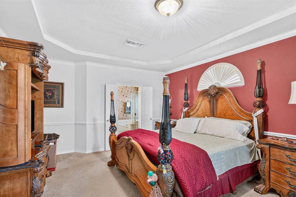 10657 Coach House Lane, Frisco, TX 75035 Primary bedroom with a tray ceiling, generous floor space and an adjoining bathroom.