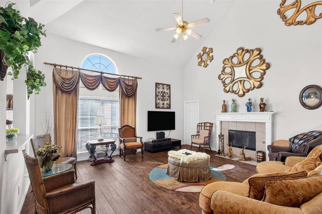 10657 Coach House Lane, Frisco, TX 75035 Main living room with a gas fireplace, tall windows and a high ceiling.