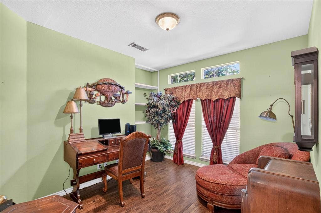 10657 Coach House Lane, Frisco, TX 75035 Home office space with built-in shelving and a large window.
