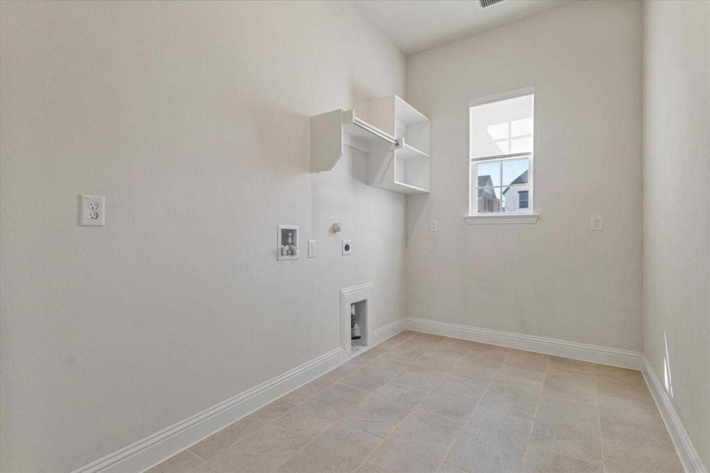 2817 Yarmouth Street, Celina, TX 75009 Utility space featuring tile flooring, a single window with muntins, and built-in wall shelving with a hanging rod