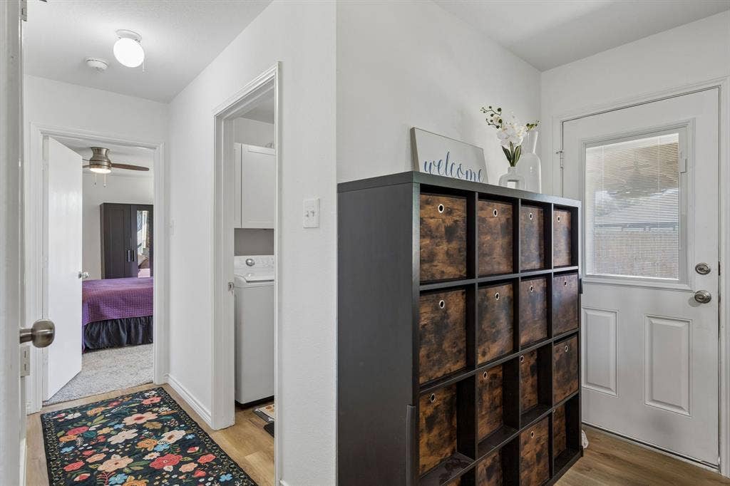 View from the kitchen leading into the utility room and primary bedroom.