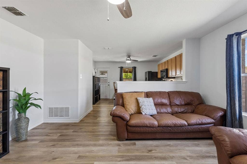 View of the living room showcasing the seamless flow into the kitchen and dining area.
