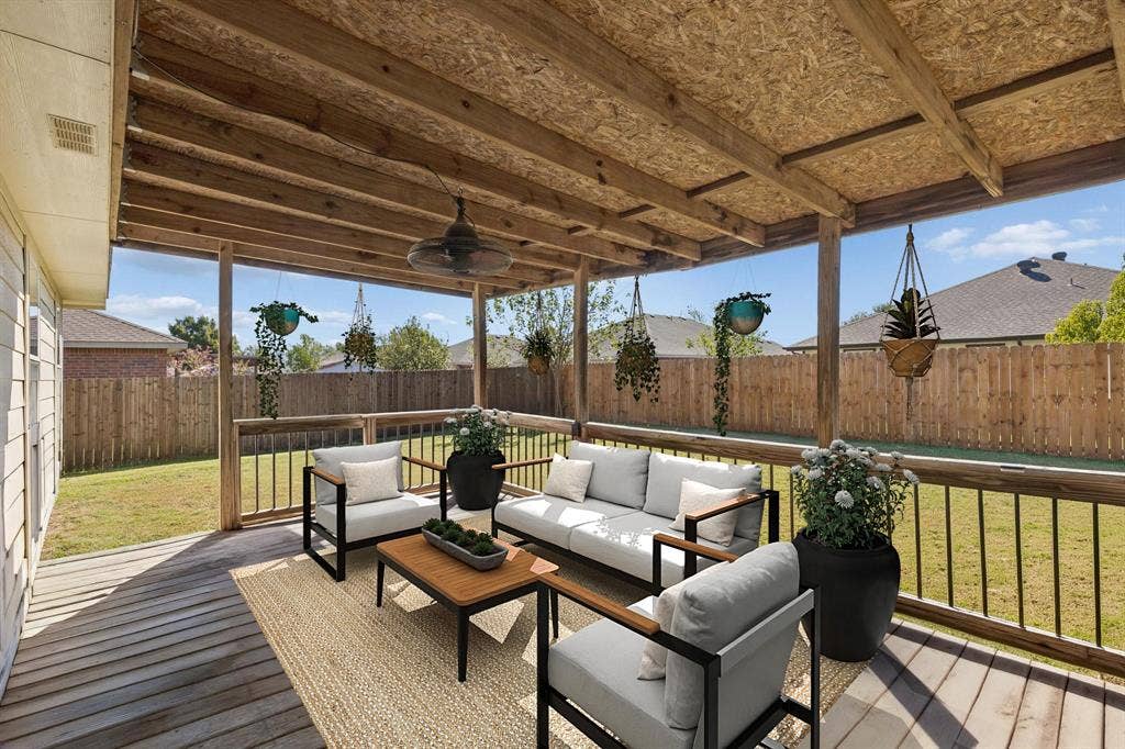 Enjoy the spacious covered patio just off the back door, complete with a ceiling fan and overlooking a huge backyard perfect for relaxing or entertaining!