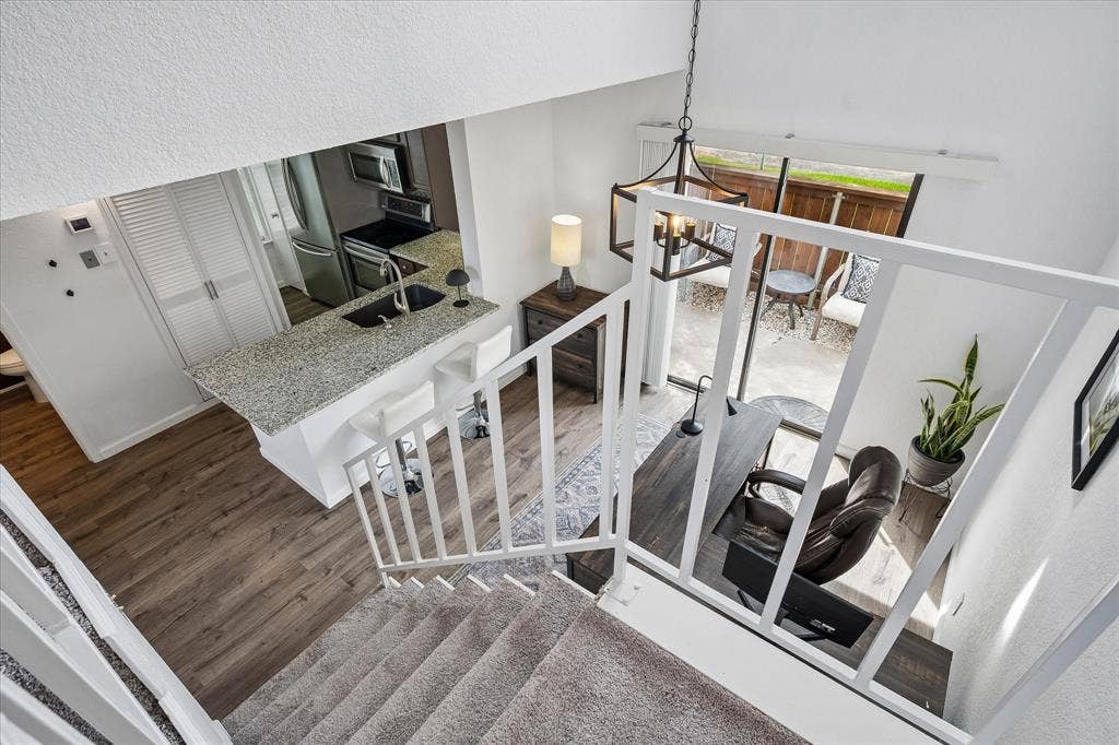 View from staircase looking into dining/ study area, kitchen and backyard patio!