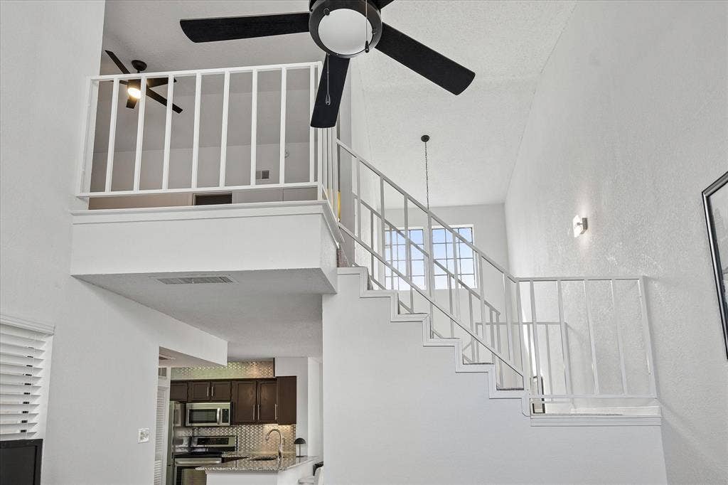 Stairway view from living area. Primary bedroom is lofted and overlooks the living area.