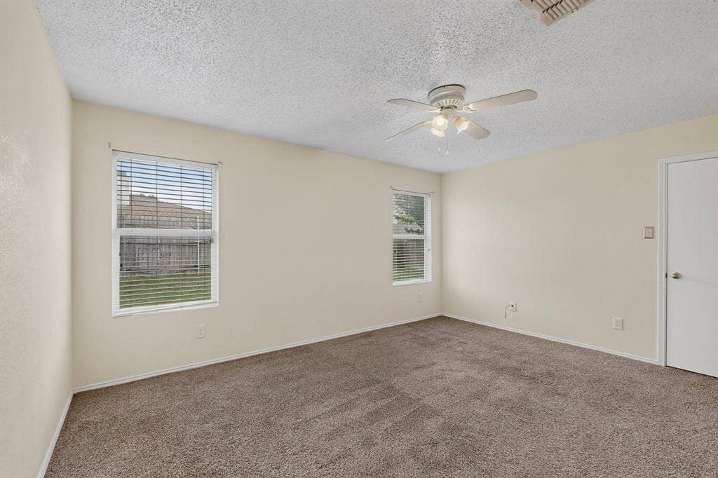 3107 Westview Drive, McKinney, TX 75070 Neutral-toned walls, textured ceiling, carpeting, ceiling-mounted fan with light fixture, and windows with horizontal blinds