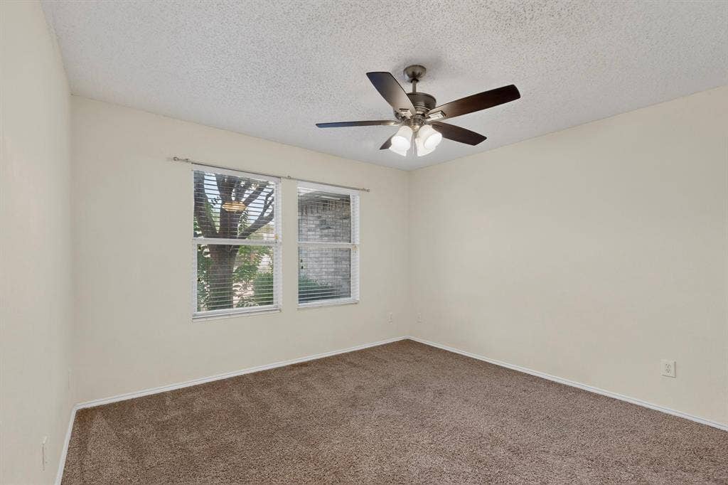 3107 Westview Drive, McKinney, TX 75070 Neutral-toned walls, carpeting, dual windows with horizontal blinds, and a multi-blade ceiling fan with integrated lighting