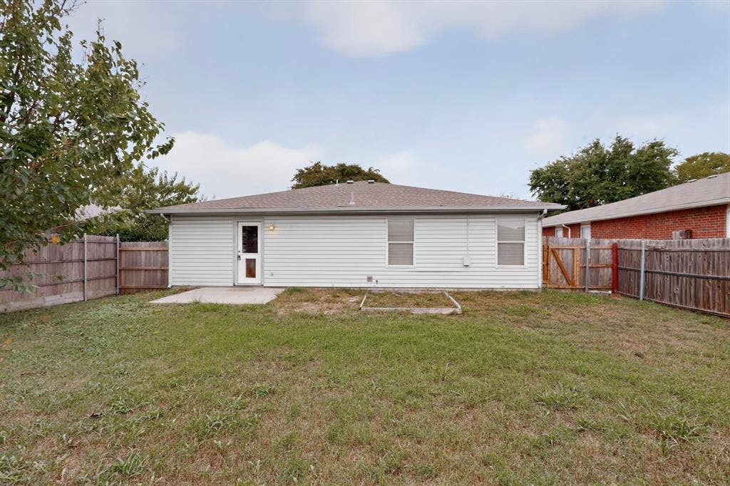 3107 Westview Drive, McKinney, TX 75070 Rear exterior featuring horizontal vinyl siding, a concrete patio, and a fenced-in yard