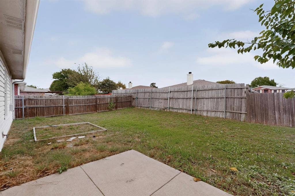 3107 Westview Drive, McKinney, TX 75070 Backyard featuring a concrete patio, wood fence, and grass lawn