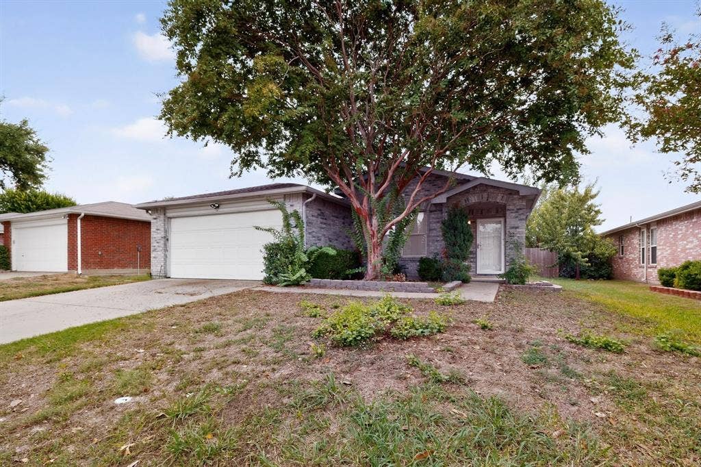 3107 Westview Drive, McKinney, TX 75070 Single-story brick exterior featuring a front-facing attached two-car garage, concrete driveway, and mature landscaping