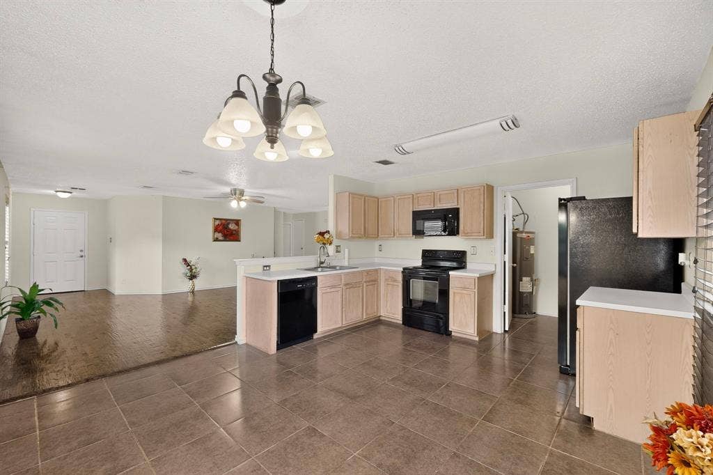 3107 Westview Drive, McKinney, TX 75070 Kitchen featuring light-finish cabinetry, black appliances, tile flooring, and a multi-arm chandelier