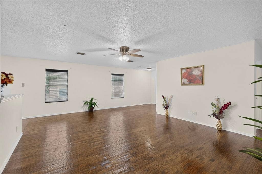 3107 Westview Drive, McKinney, TX 75070 Living area featuring wood-finish flooring, neutral wall paint, and a ceiling-mounted fan with integrated lighting