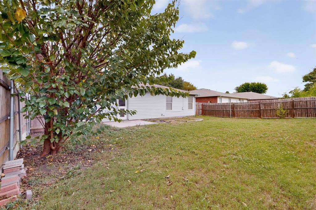 3107 Westview Drive, McKinney, TX 75070 Backyard featuring a concrete patio, wood privacy fencing, and mature trees