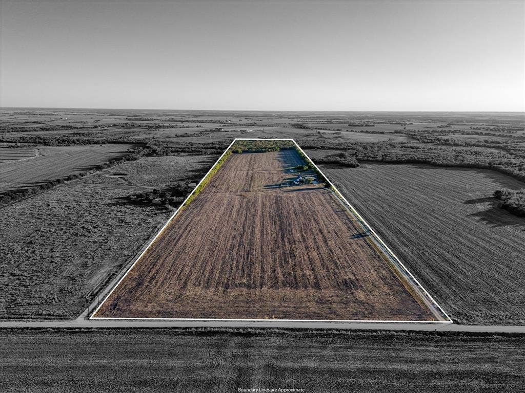23010 Rosebud Road, Burlington, TX 76519 Expansive acreage featuring cleared land, mature perimeter tree lines, and frontage on a public road