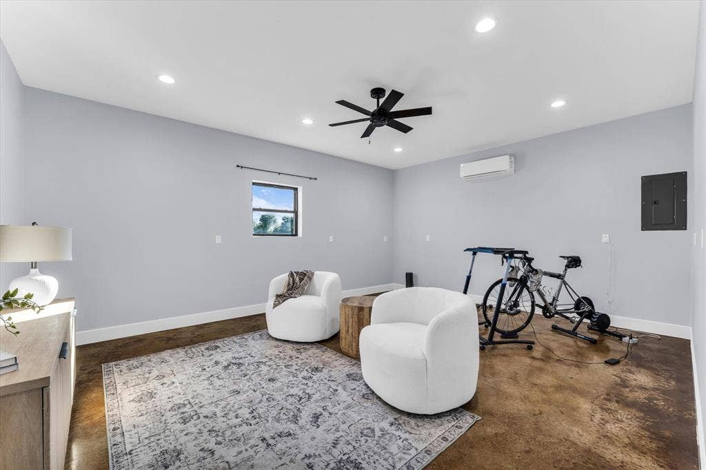 23010 Rosebud Road, Burlington, TX 76519 Polished concrete flooring, recessed lighting, matte black ceiling fan, and wall-mounted ductless climate control unit
