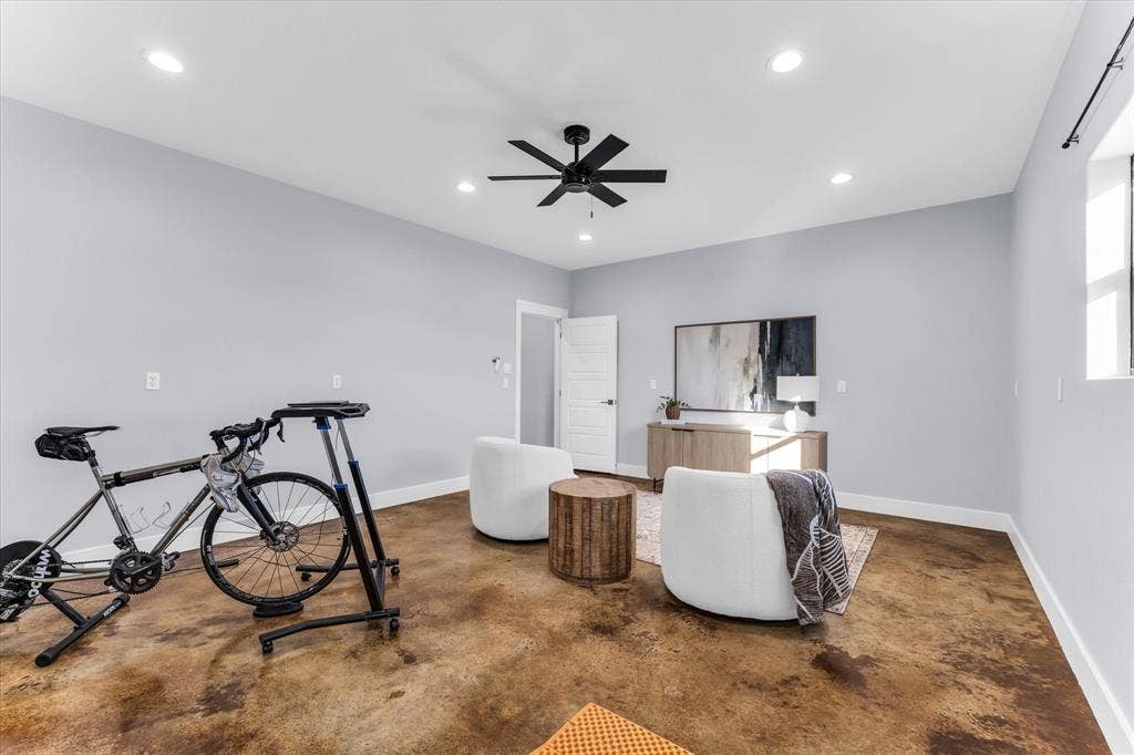 23010 Rosebud Road, Burlington, TX 76519 Stained concrete flooring, recessed lighting, and a matte black ceiling fan