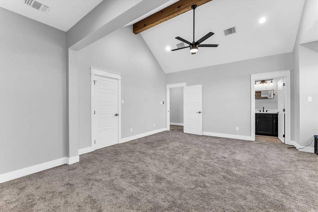 23010 Rosebud Road, Burlington, TX 76519 Vaulted ceiling with an exposed wood beam, recessed lighting, and a modern ceiling fan