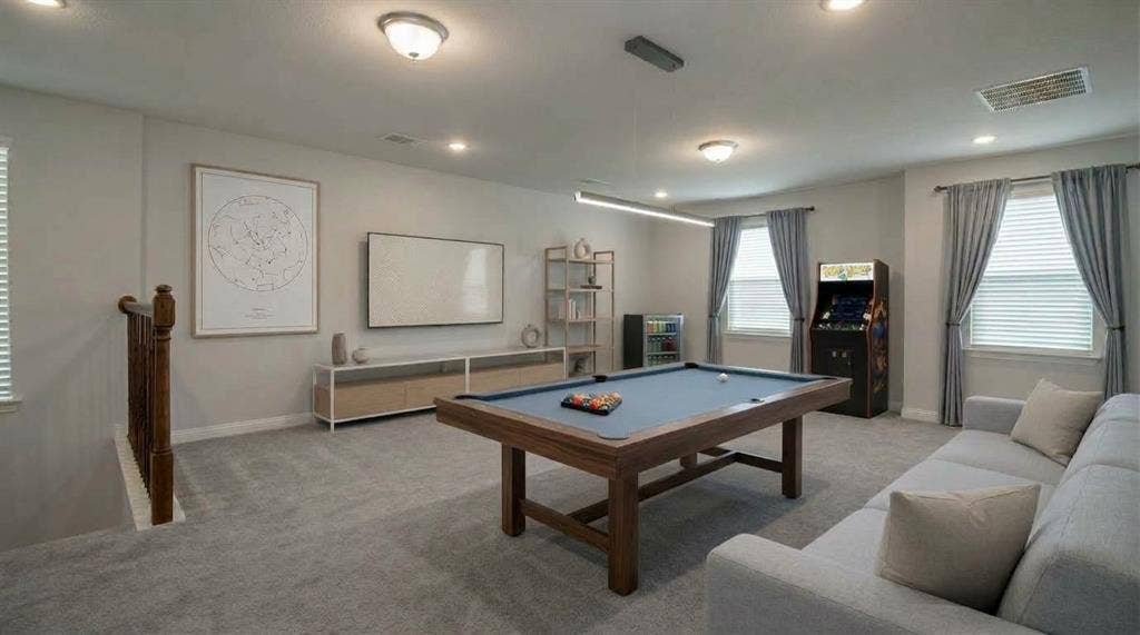 Neutral wall-to-wall carpeting, wood-finish stair railing with balusters, recessed lighting, and multiple windows with drapery hardware