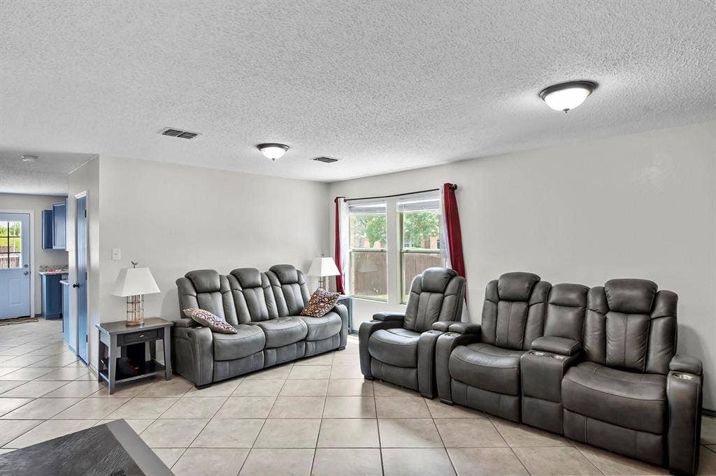 600 Claiborn Lane, Wylie, TX 75098 Open-concept interior featuring large-format diagonal tile flooring, neutral wall tones, and recessed ceiling lighting throughout