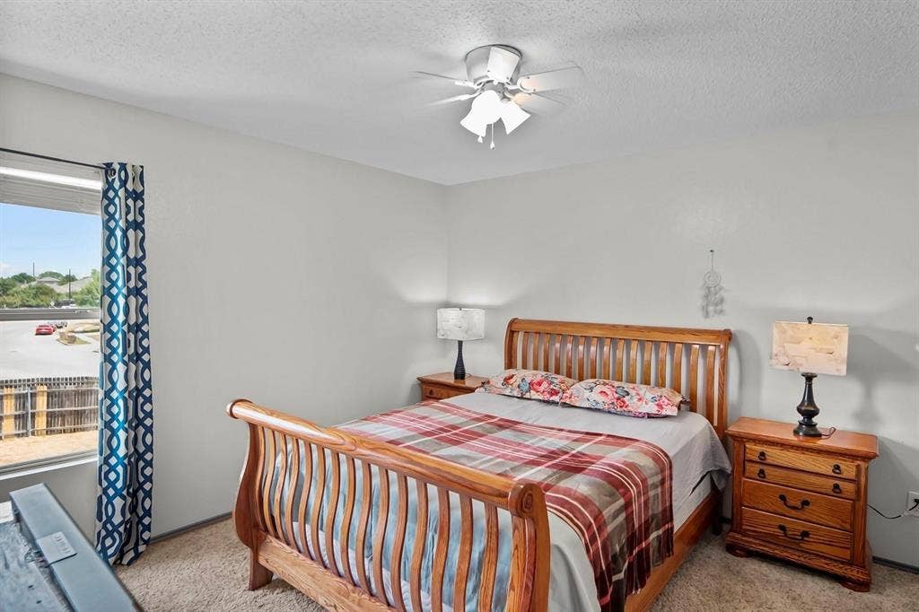 600 Claiborn Lane, Wylie, TX 75098 Neutral wall tones, carpeted flooring, and a ceiling-mounted light fixture with a fan