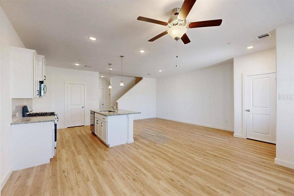 1428 Starlight Trail, Mesquite, TX 75181 Kitchen featuring white cabinets, recessed lighting, light stone countertops, and decorative light fixtures