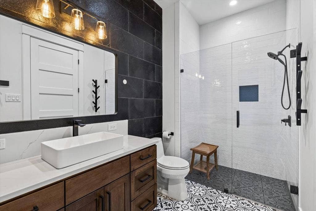 104 Oakbend Trail, Mabank, TX 75147 En suite Bath Two features a walk-in shower and exterior access to the patio for added convenience. Main Residence.