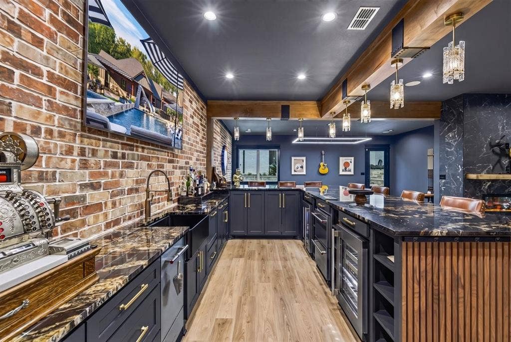104 Oakbend Trail, Mabank, TX 75147 Custom-designed bar with beautiful stone countertops, brick accent wall, beverage refrigerators, and extensive cabinetry.
