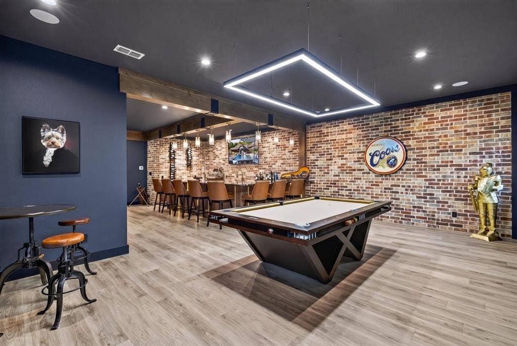 104 Oakbend Trail, Mabank, TX 75147 Expansive game room featuring a pool table, custom lighting, and a full bar with seating for guests.