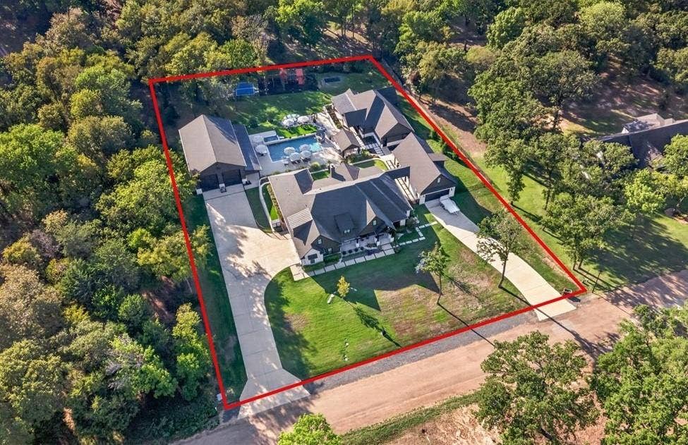104 Oakbend Trail, Mabank, TX 75147 Aerial view showcasing the property's impressive layout, multiple structures, expansive outdoor amenities, and wooded surroundings.