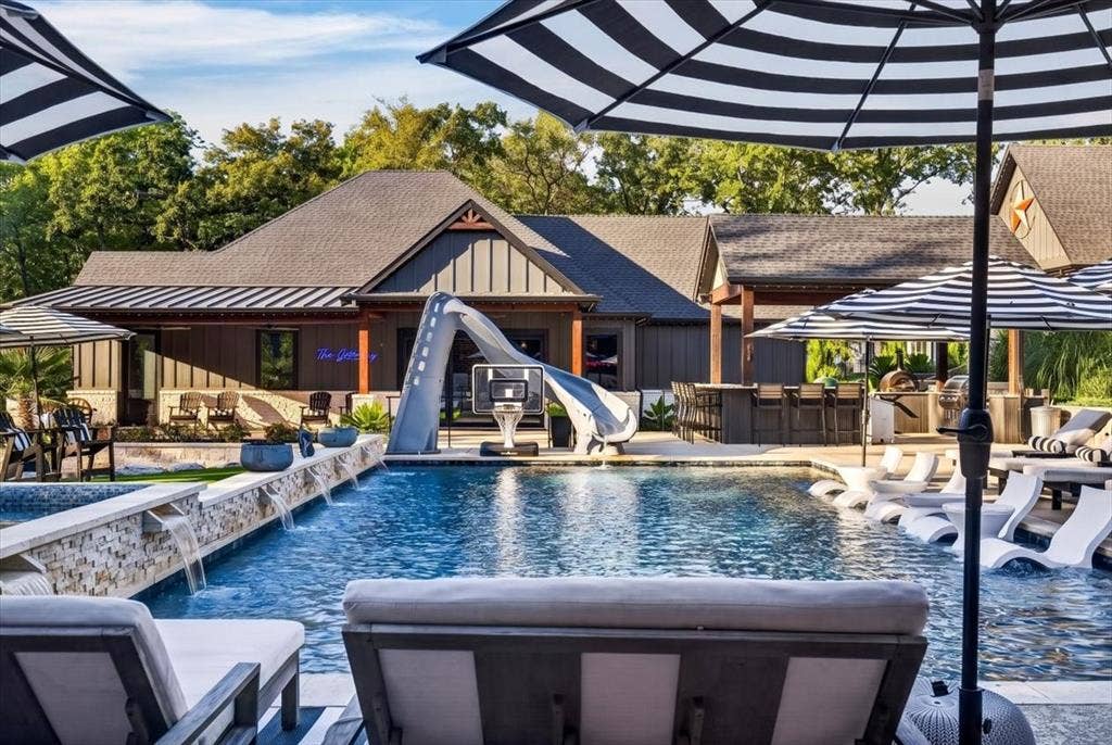 104 Oakbend Trail, Mabank, TX 75147 Outdoor oasis with heated and chilled salt water pool with water slide and hot tub.