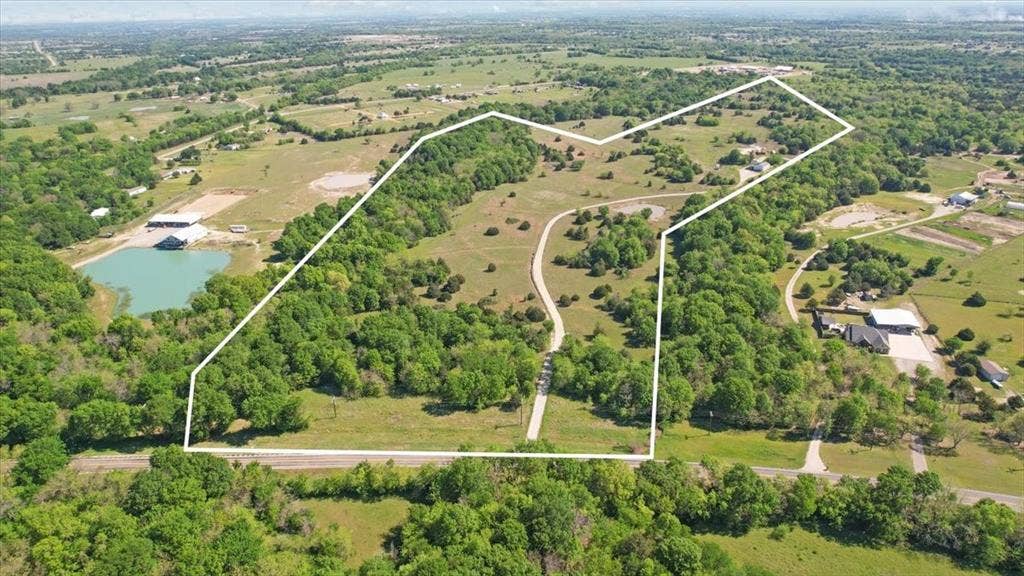 2377 FM 36 N, Farmersville, TX 75442 Expansive acreage featuring mature tree lines, open pasture, and a dedicated gravel drive