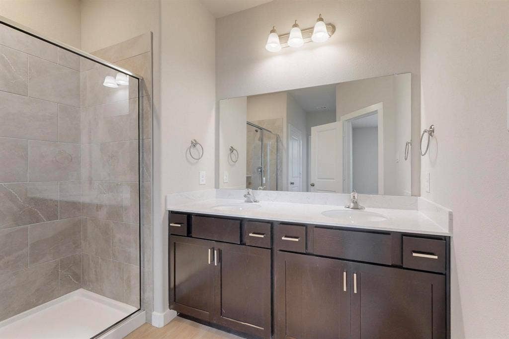 1432 Starlight Trail, Mesquite, TX 75181 Bathroom with a shower stall, double vanity, and light wood-style floors