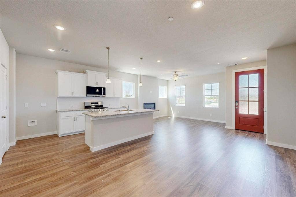 1500 Starlight Trail, Mesquite, TX 75181 Kitchen with pendant lighting, an island with sink, open floor plan, white cabinetry, and appliances with stainless steel finishes