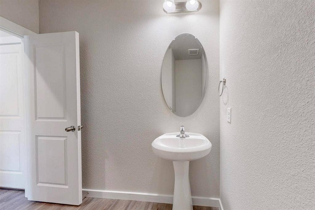 1500 Starlight Trail, Mesquite, TX 75181 Bathroom with baseboards and light wood finished floors