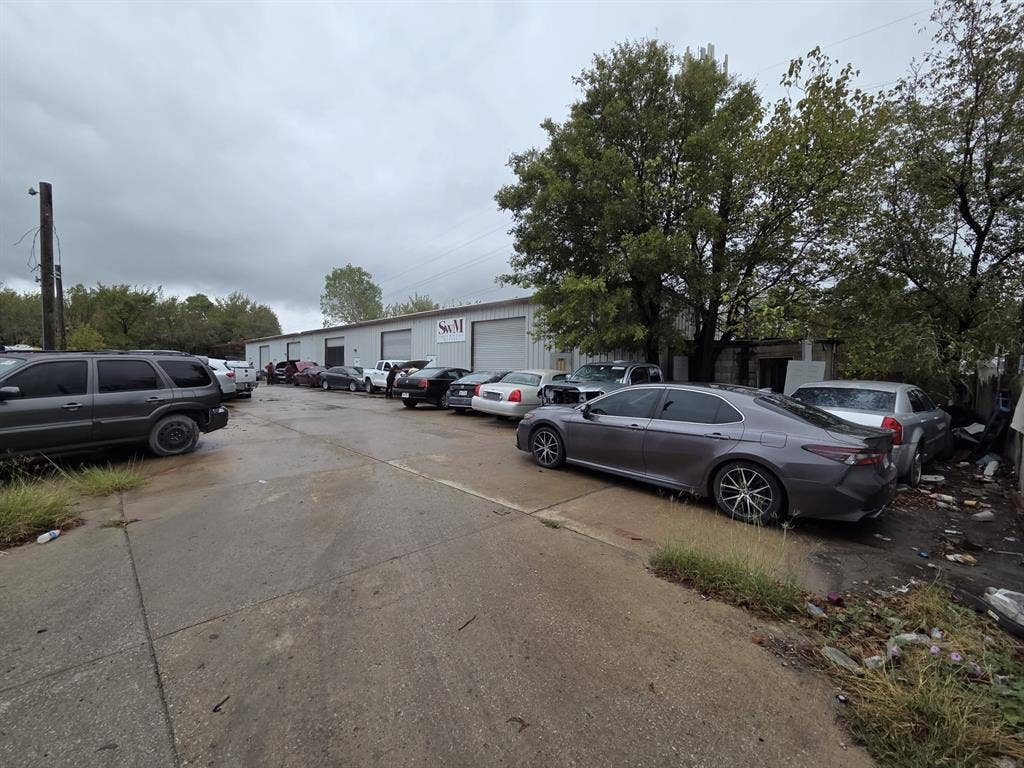 2319 Cartwright Street, Dallas, TX 75212 Industrial building featuring a metal exterior, multiple bay doors, and a paved concrete parking lot