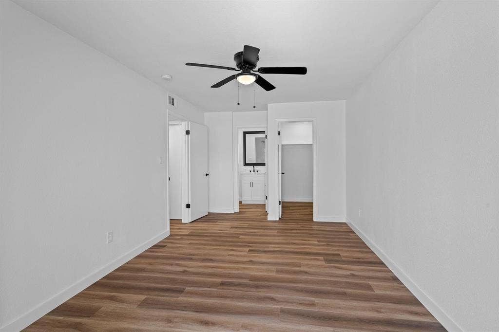 2621 Amherst Court, Irving, TX 75038 Neutral interior featuring wood-finish flooring, a central ceiling fan with integrated lighting, and white walls