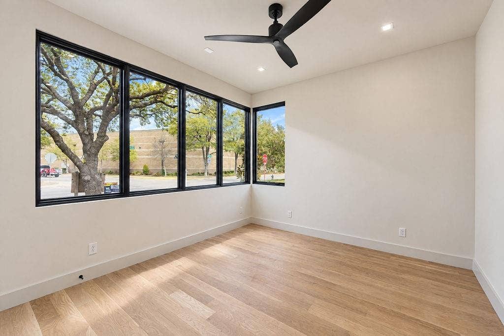 Wake up at your own pace in a spacious ground-floor bedroom surrounded by black-cased windows and a refreshing ceiling fan breeze