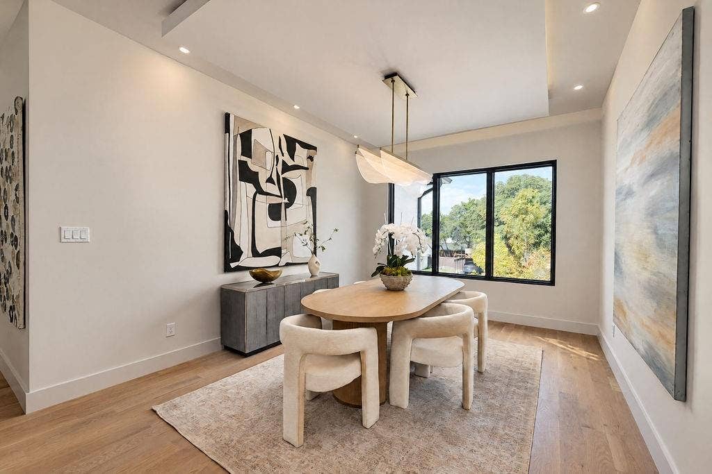 Share home-cooked dinners beneath a designer light in a dining niche right off the main kitchen