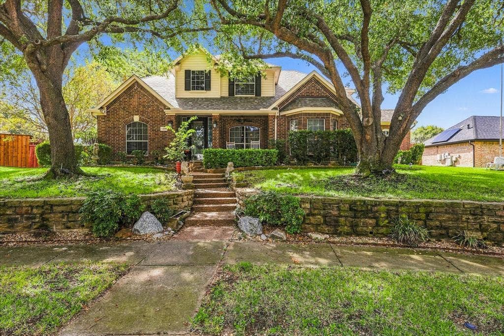 1906 Chapel Cove, Rowlett, TX 75088 Stately curb appeal with a home framed by towering mature trees.