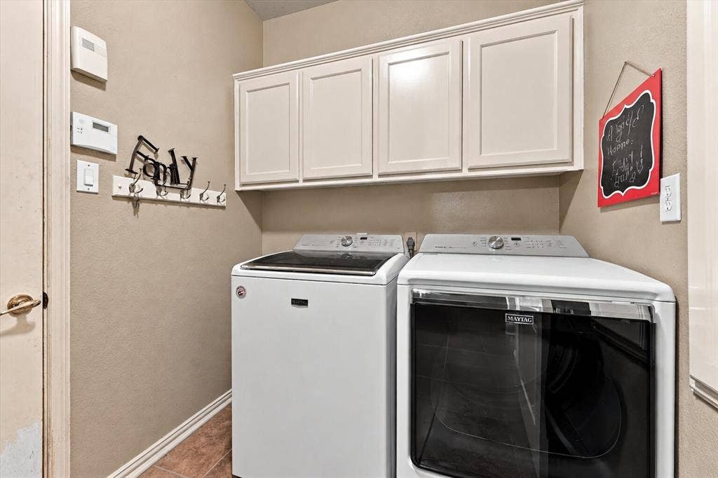 1906 Chapel Cove, Rowlett, TX 75088 Laundry room with cabinetry for extra storage.