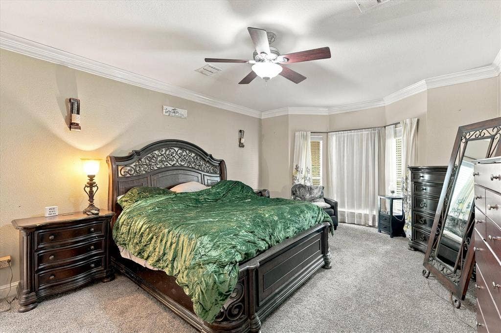 1906 Chapel Cove, Rowlett, TX 75088 Primary bedroom with bay window overlooking shaded front yard and cul-de-sac.