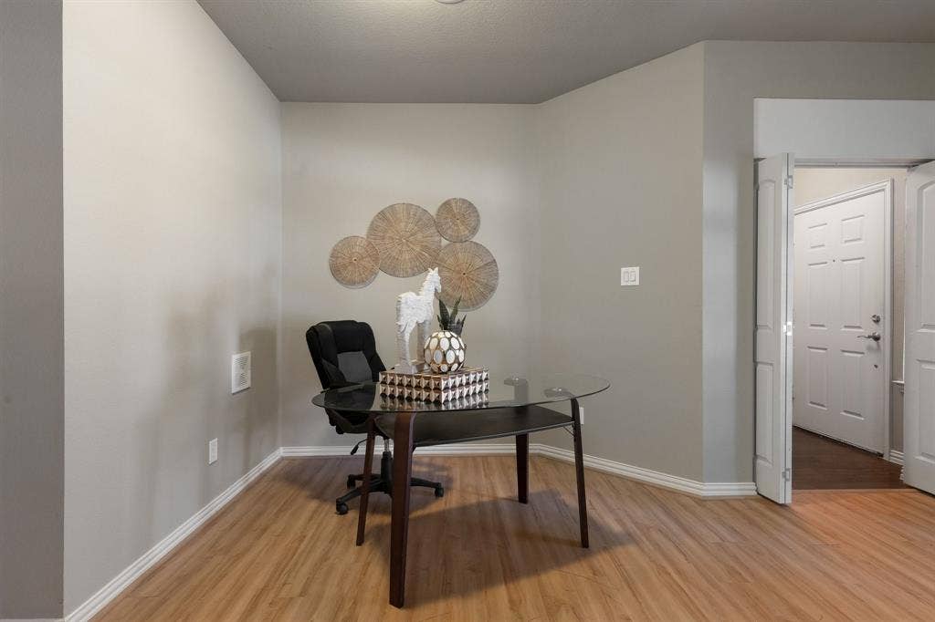 Neutral wall tones, wood-finish flooring, and paneled interior doors